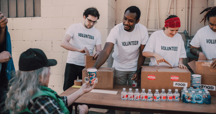 Volunteers donating food and drinks to those in need