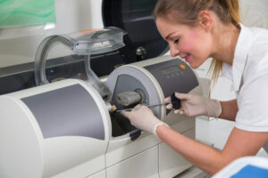 Dental assistant creating a same-day crown using CEREC